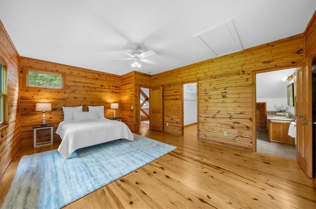 470 Sautee Ridge Road Clarkesville, GA 30523 - Photo 19 of 37 a spacious bedroom with a bed and wooden floor