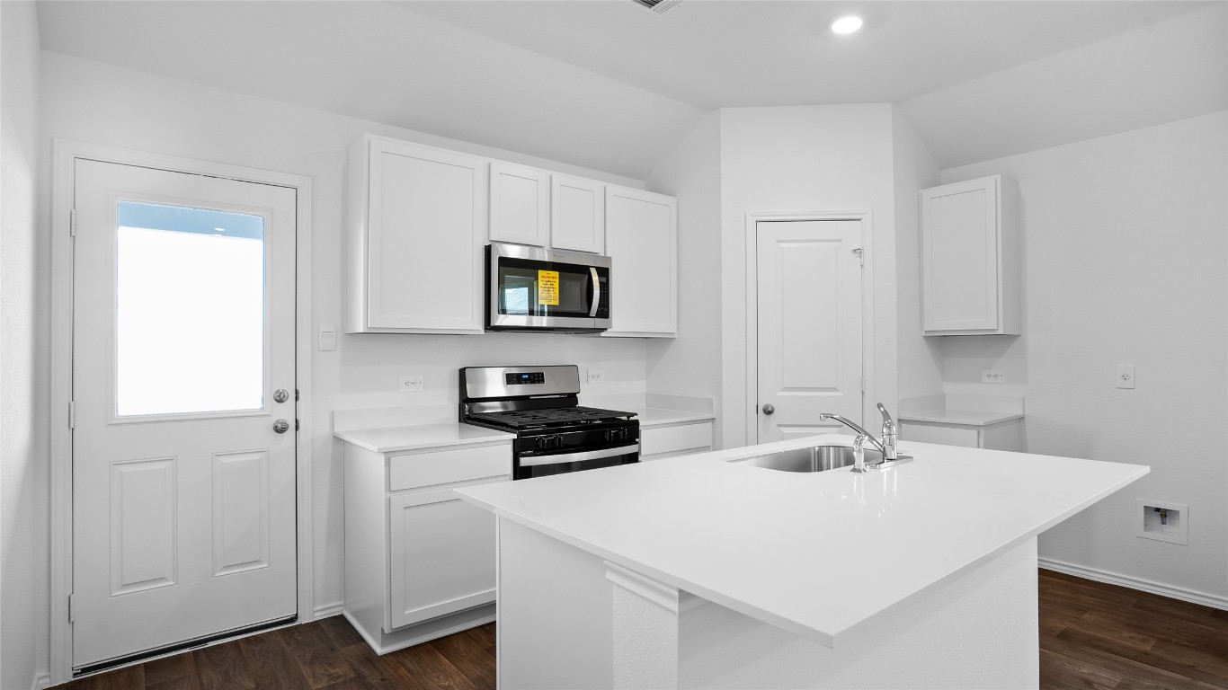 105 Celosia Loop Kyle, TX 78640 - Photo 11 of 14 a kitchen with a sink a stove and cabinets