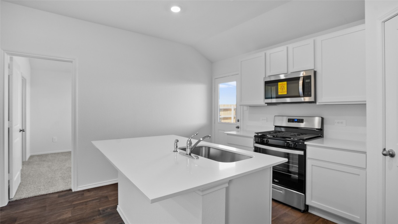 105 Celosia Loop Kyle, TX 78640 - Photo 8 of 14 a kitchen with a sink a microwave and cabinets