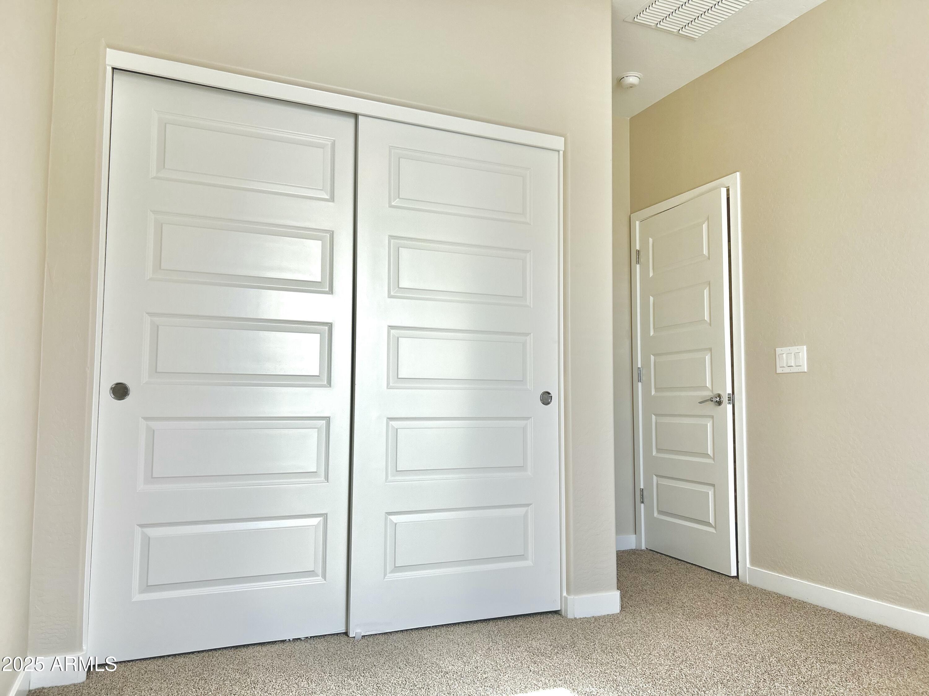 4038 East Erie Street, Unit 103 Gilbert, AZ 85295 - Photo 12 of 16 a view of an empty walk in closet