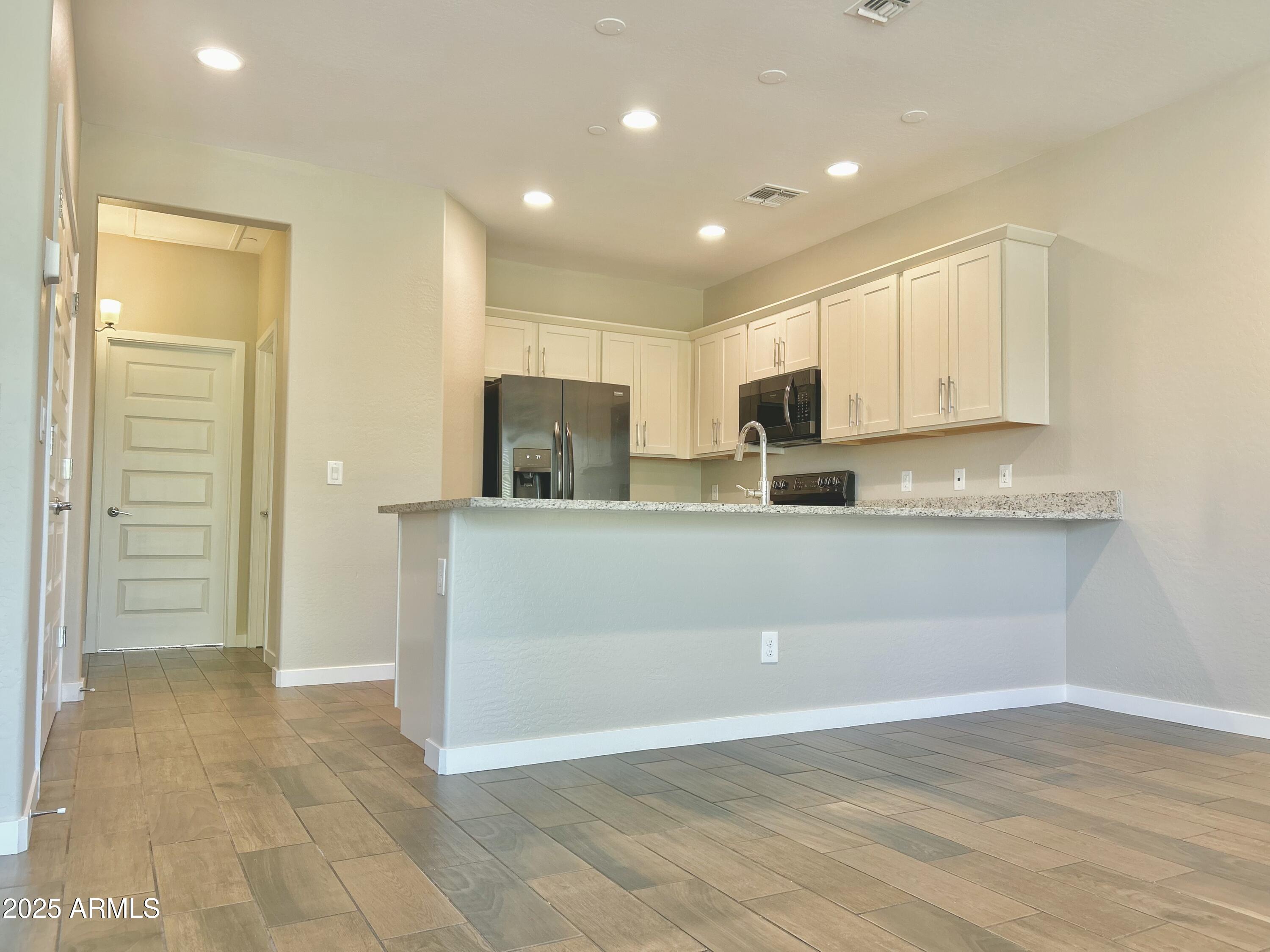 4038 East Erie Street, Unit 103 Gilbert, AZ 85295 - Photo 8 of 16 a view of kitchen with wooden floor