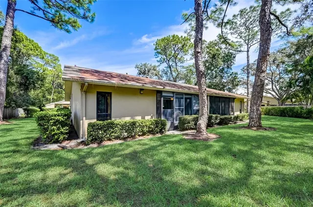 a view of a house with backyard sitting area and garden