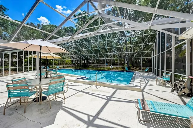 a view of a chair and tables in the patio