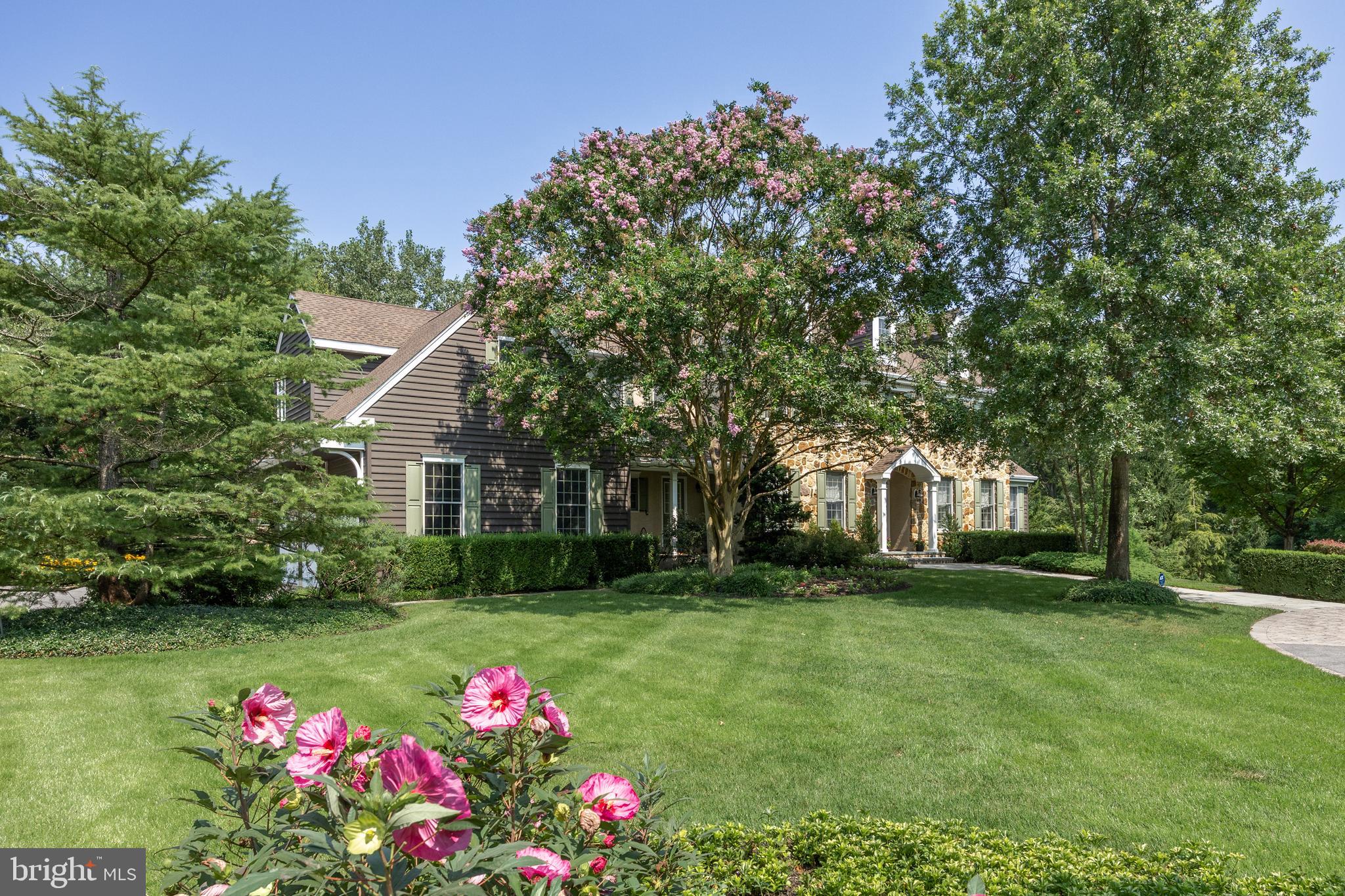 a front view of house with yard and trees