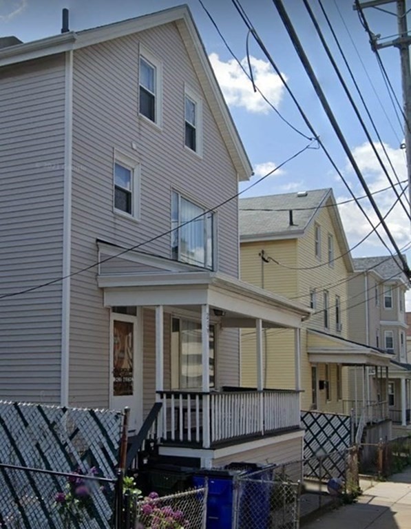 a view of a house with wooden fence