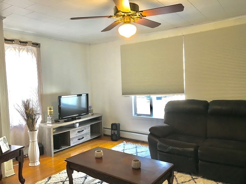 219 William Street Fall River, MA 02721 - Photo 6 of 14 a living room with furniture and a flat screen tv
