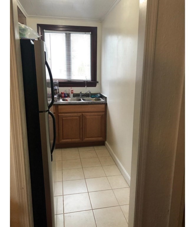 219 William Street Fall River, MA 02721 - Photo 9 of 14 a view of kitchen with a refrigerator washer and dryer
