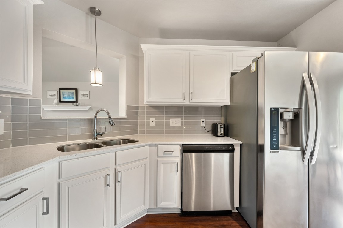 2004 Yaupon Trail Cedar Park, TX 78613 - Photo 13 of 33 a kitchen with white cabinets and stainless steel appliances