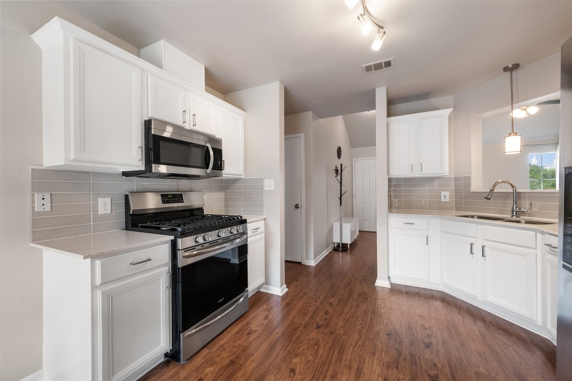 2004 Yaupon Trail Cedar Park, TX 78613 - Photo 17 of 33 a kitchen with a stove a sink and a refrigerator