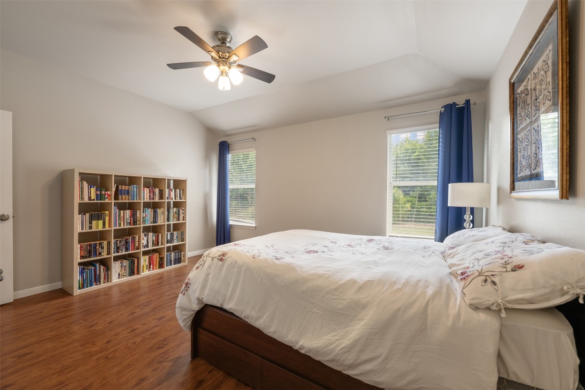2004 Yaupon Trail Cedar Park, TX 78613 - Photo 20 of 33 a bedroom with a large bed and a chandelier