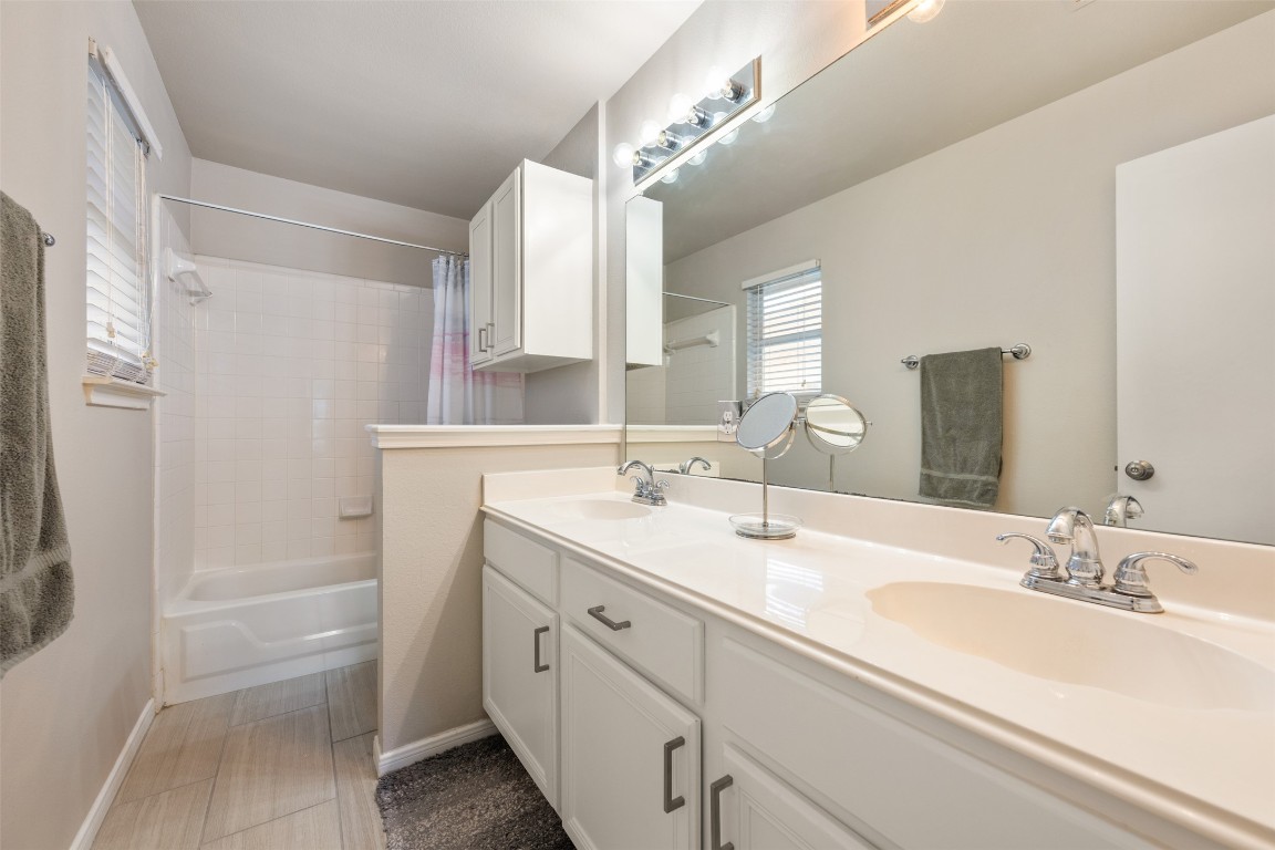 2004 Yaupon Trail Cedar Park, TX 78613 - Photo 21 of 33 a bathroom with a double vanity sink a mirror and a shower