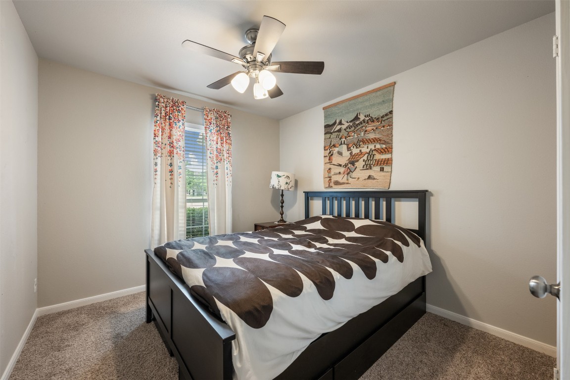 2004 Yaupon Trail Cedar Park, TX 78613 - Photo 23 of 33 a bedroom with a bed and a chandelier