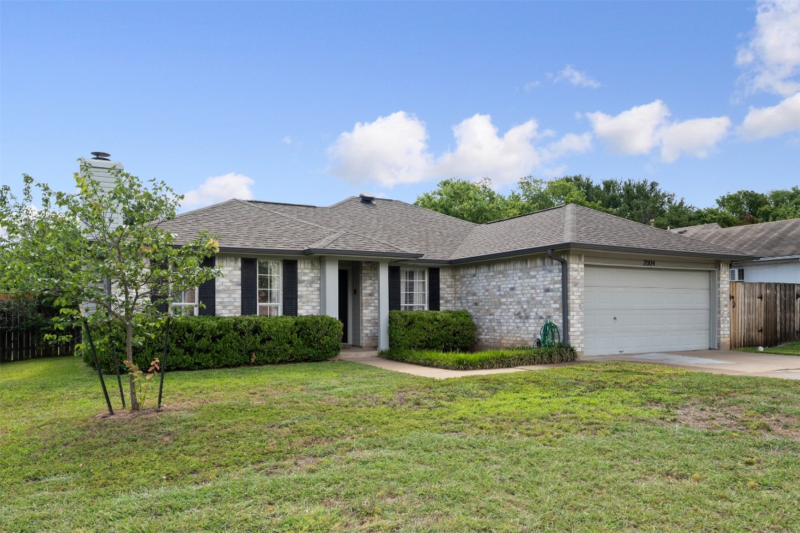 2004 Yaupon Trail Cedar Park, TX 78613 - Photo 3 of 33 a front view of a house with a yard and garage