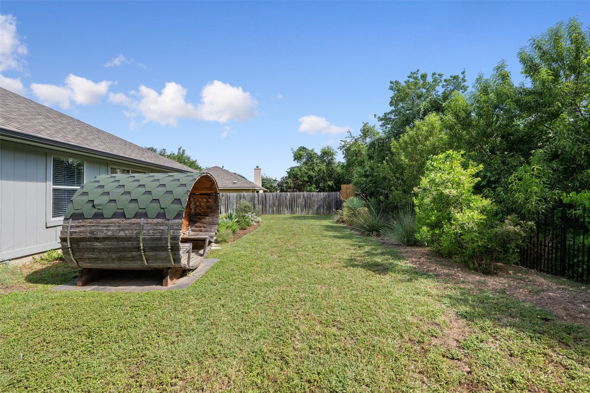 2004 Yaupon Trail Cedar Park, TX 78613 - Photo 31 of 33 a backyard of a house with a garden and barbeque oven