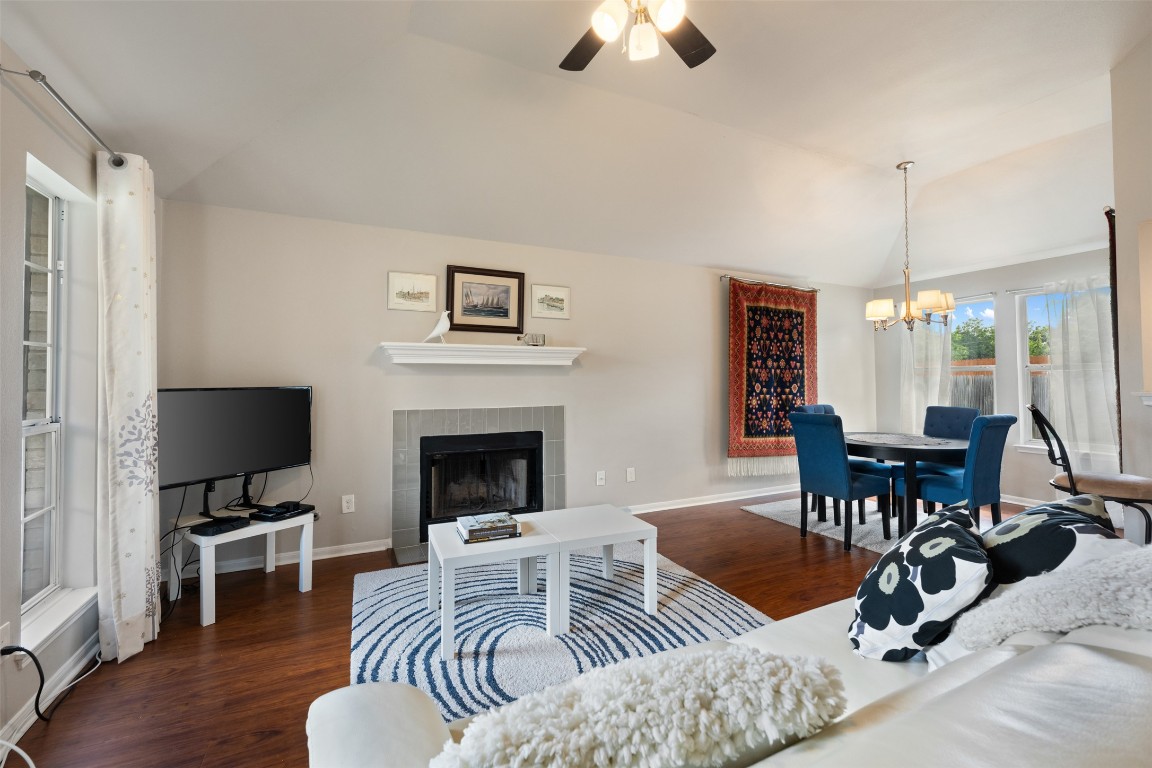 2004 Yaupon Trail Cedar Park, TX 78613 - Photo 7 of 33 a view of a livingroom with furniture a fireplace wooden floor and a chandelier