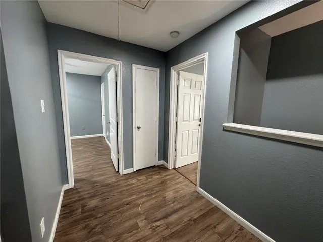 a view of hallway with wooden floor