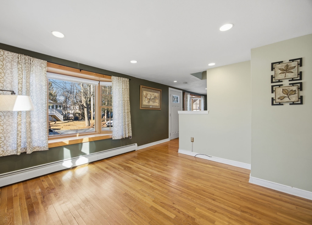 55 Maynard Road Dedham, MA 02026 - Photo 11 of 38 an empty room with wooden floor and windows