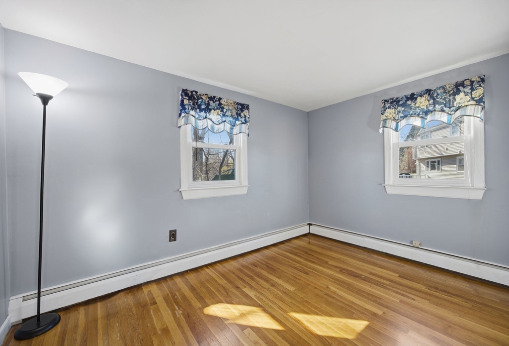 55 Maynard Road Dedham, MA 02026 - Photo 15 of 38 a view of a room with wooden floor and window