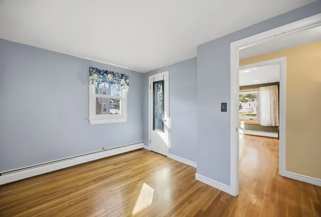 a view of empty room with wooden floor