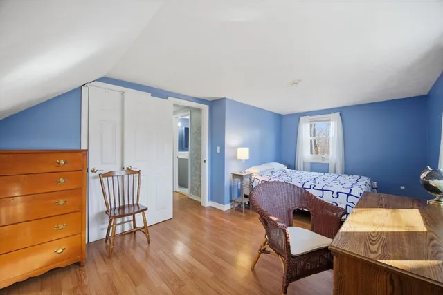 a bedroom with a bed and a dresser in it