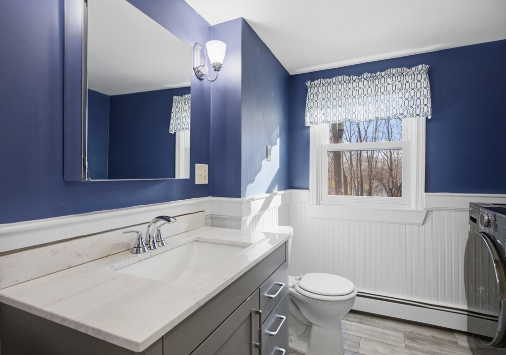 55 Maynard Road Dedham, MA 02026 - Photo 24 of 38 a bathroom with a sink vanity mirror and toilet