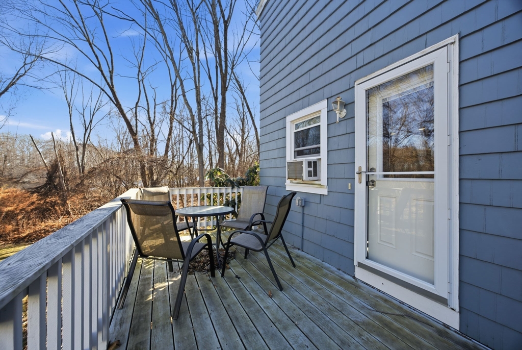 55 Maynard Road Dedham, MA 02026 - Photo 27 of 38 a view of a roof deck with table and chairs and wooden floor