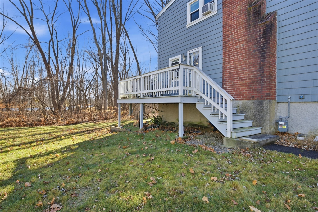 55 Maynard Road Dedham, MA 02026 - Photo 29 of 38 a view of a house with a yard and deck