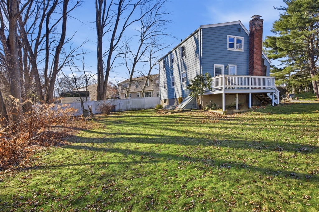 55 Maynard Road Dedham, MA 02026 - Photo 30 of 38 a view of a building with a big yard and large trees