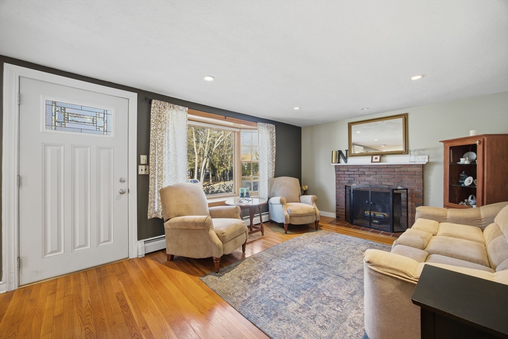 55 Maynard Road Dedham, MA 02026 - Photo 3 of 38 a living room with furniture and a fireplace
