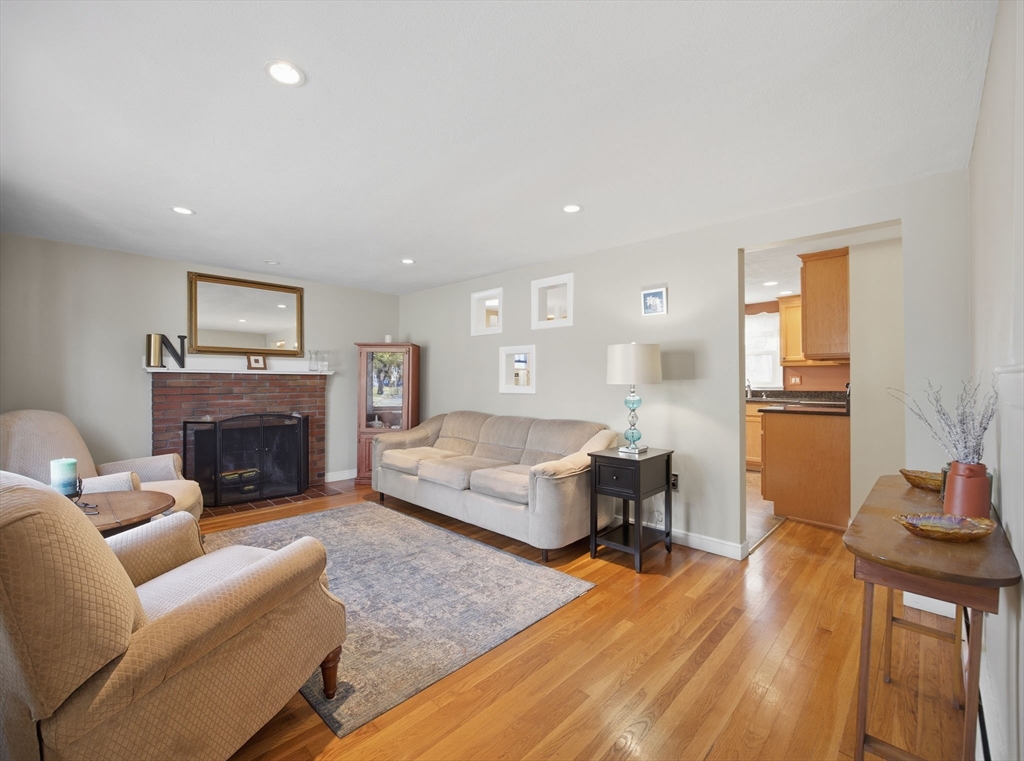55 Maynard Road Dedham, MA 02026 - Photo 4 of 38 a living room with furniture and a fireplace