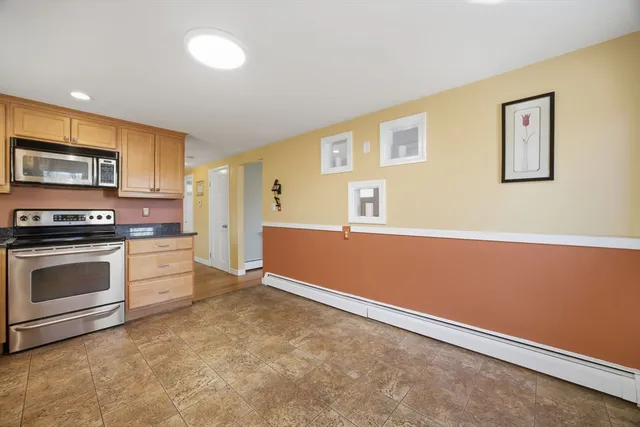a kitchen with granite countertop a stove and a refrigerator