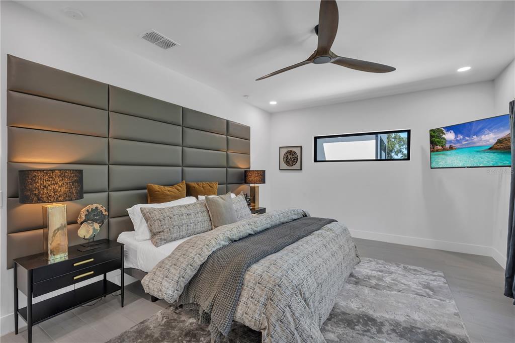 239 East Harding Street Orlando, FL 32806 - Photo 33 of 60 a bedroom with a bed and a chandelier