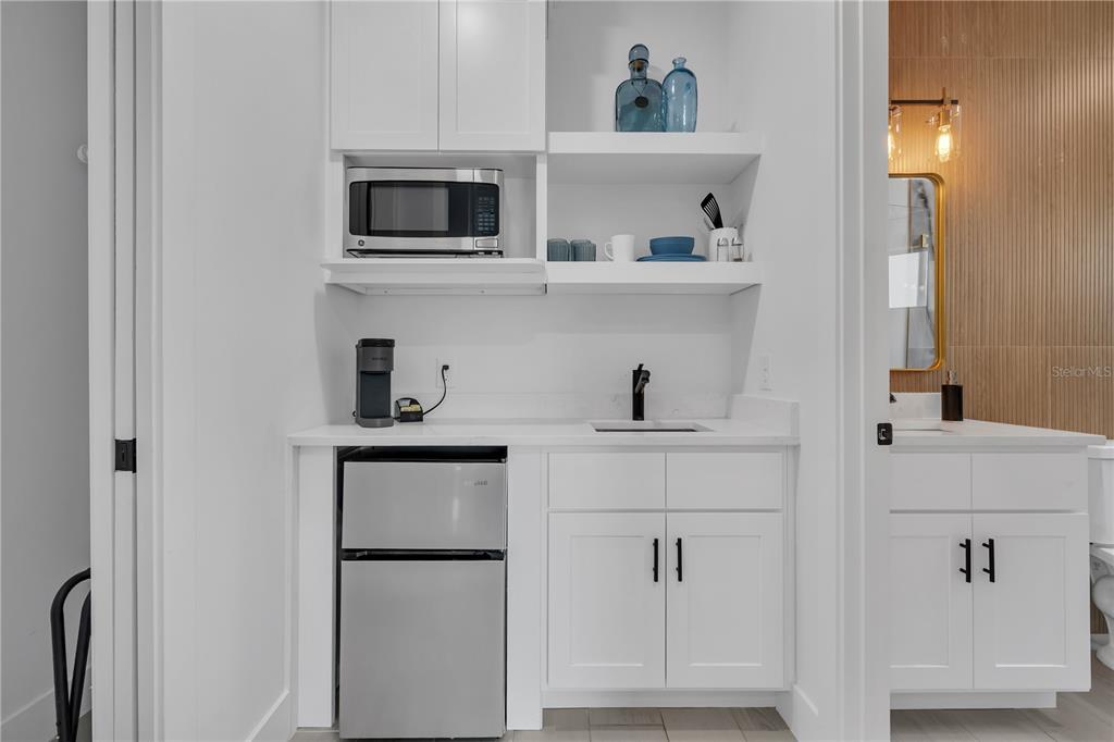 239 East Harding Street Orlando, FL 32806 - Photo 48 of 60 a kitchen with stainless steel appliances a refrigerator and cabinets