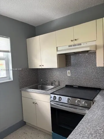 a kitchen with a sink cabinets and appliances