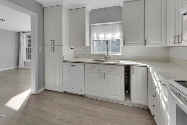a kitchen with stainless steel appliances granite countertop a sink and dishwasher a stove with wooden floor