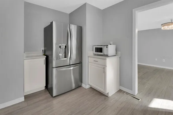 a kitchen with stainless steel appliances a refrigerator sink and microwave