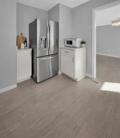 a kitchen with cabinets and stainless steel appliances