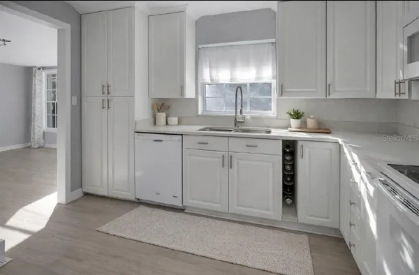 a kitchen with a sink stove and cabinets