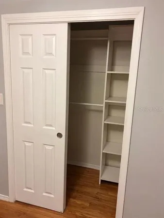 a view of walk in closet with empty racks