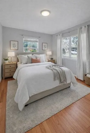 a bedroom with a large bed and a window