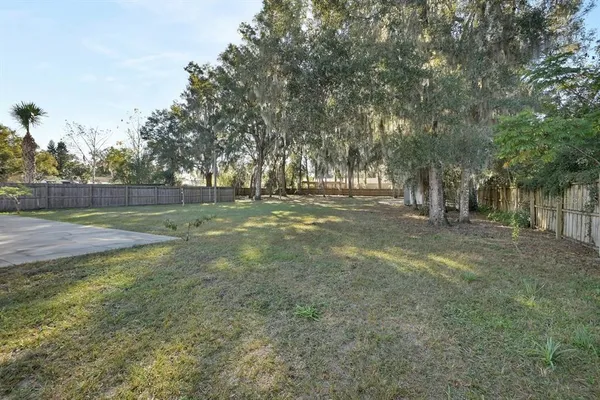 a view of a field with trees in the background
