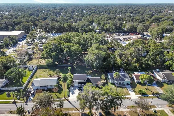 an aerial view of a houses with a yard