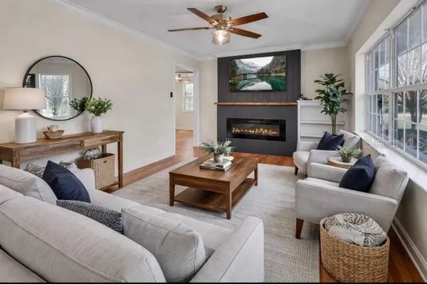 a living room with furniture a fireplace and a flat screen tv