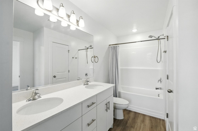 1221 West 1870 South Logan, UT 84321 - Photo 13 of 20 Modern bathroom featuring a dual-sink vanity with a light-toned countertop, brushed nickel hardware, and wood-finish flooring
