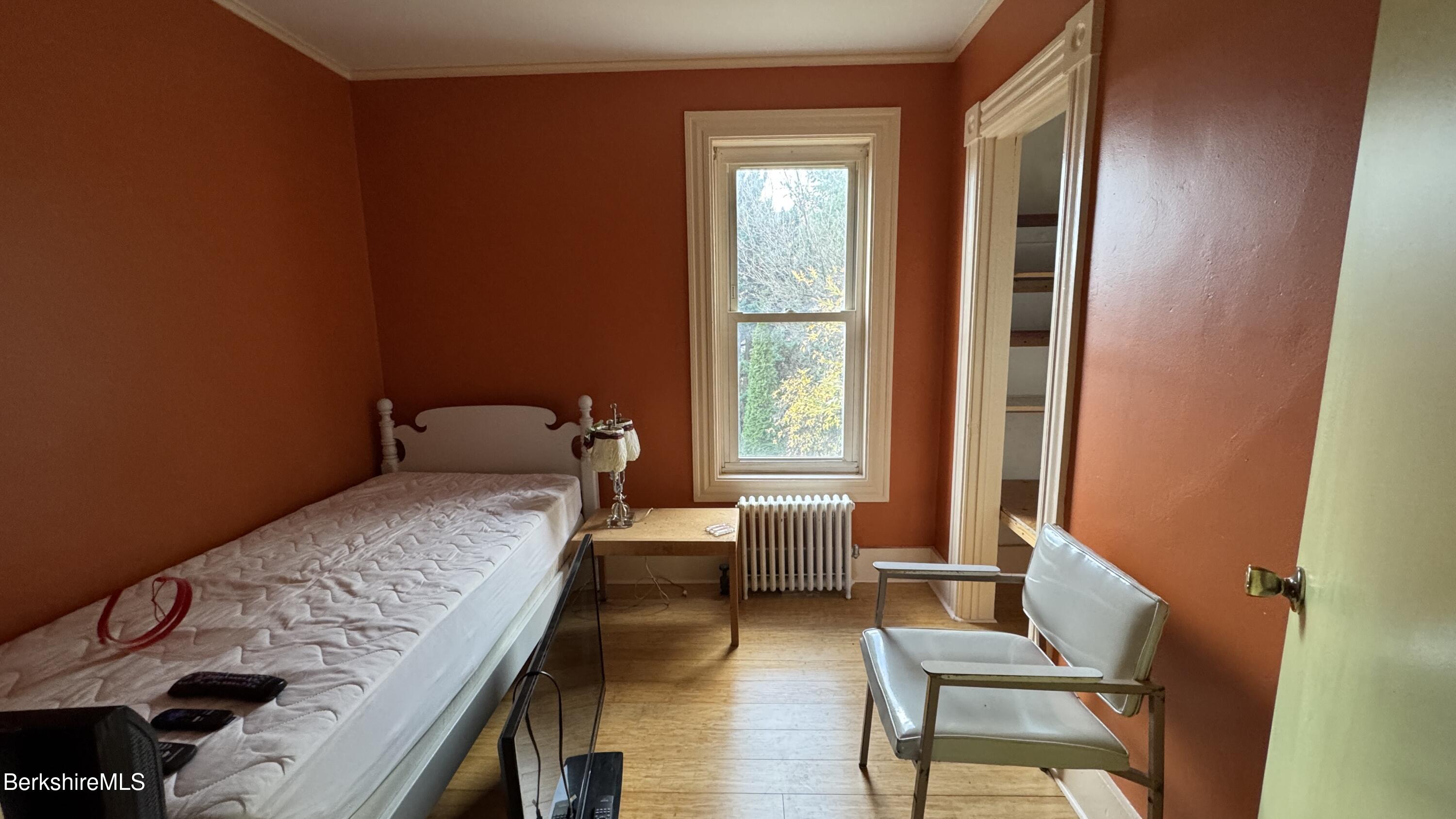 152 Furnace Street North Adams, MA 01247 - Photo 16 of 30 a bedroom with a bed and wooden floor