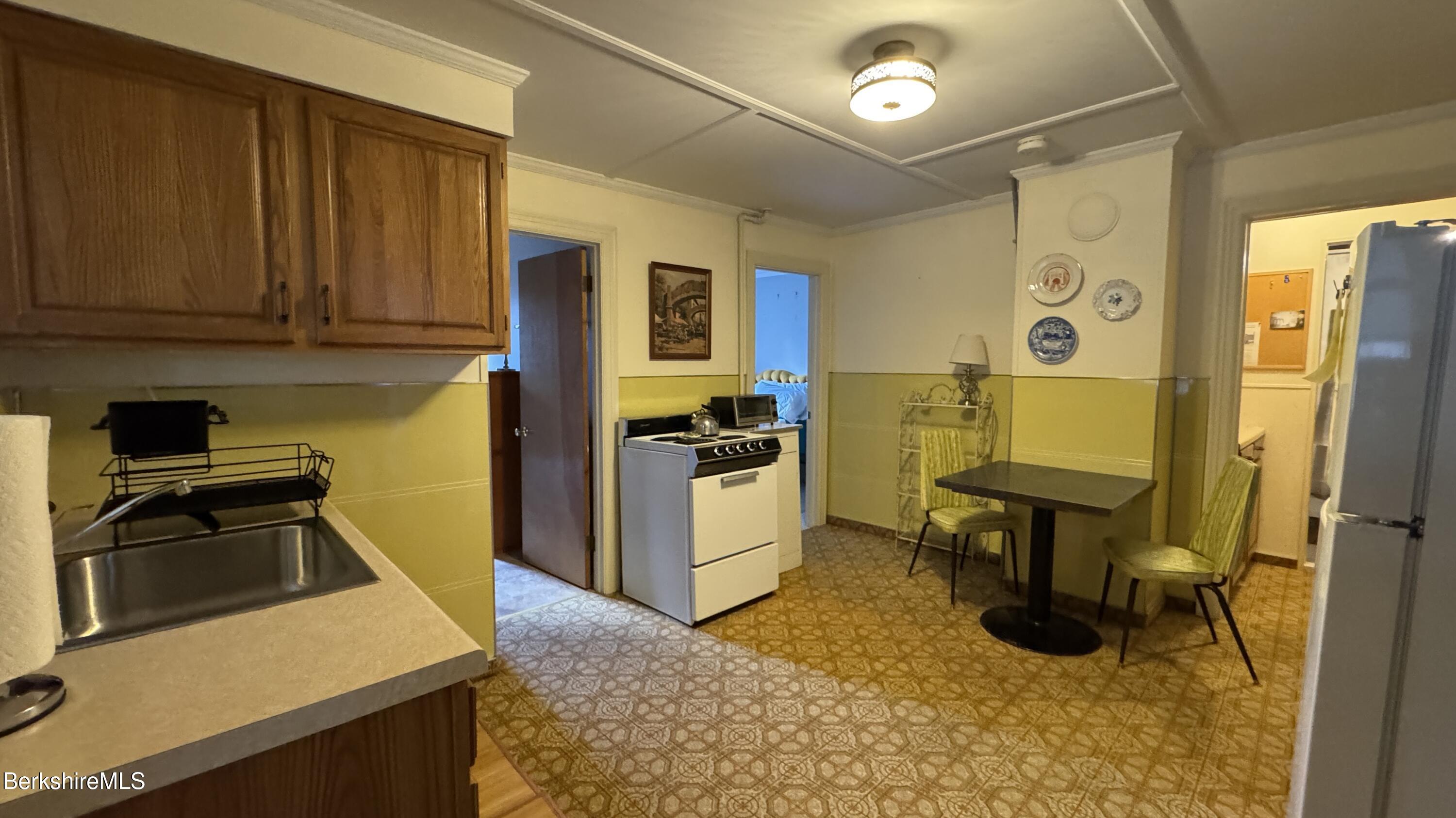 152 Furnace Street North Adams, MA 01247 - Photo 21 of 30 a kitchen with a refrigerator and a stove top oven