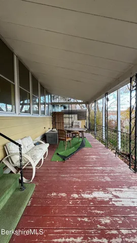 a view of a patio with a table and chairs under an umbrella