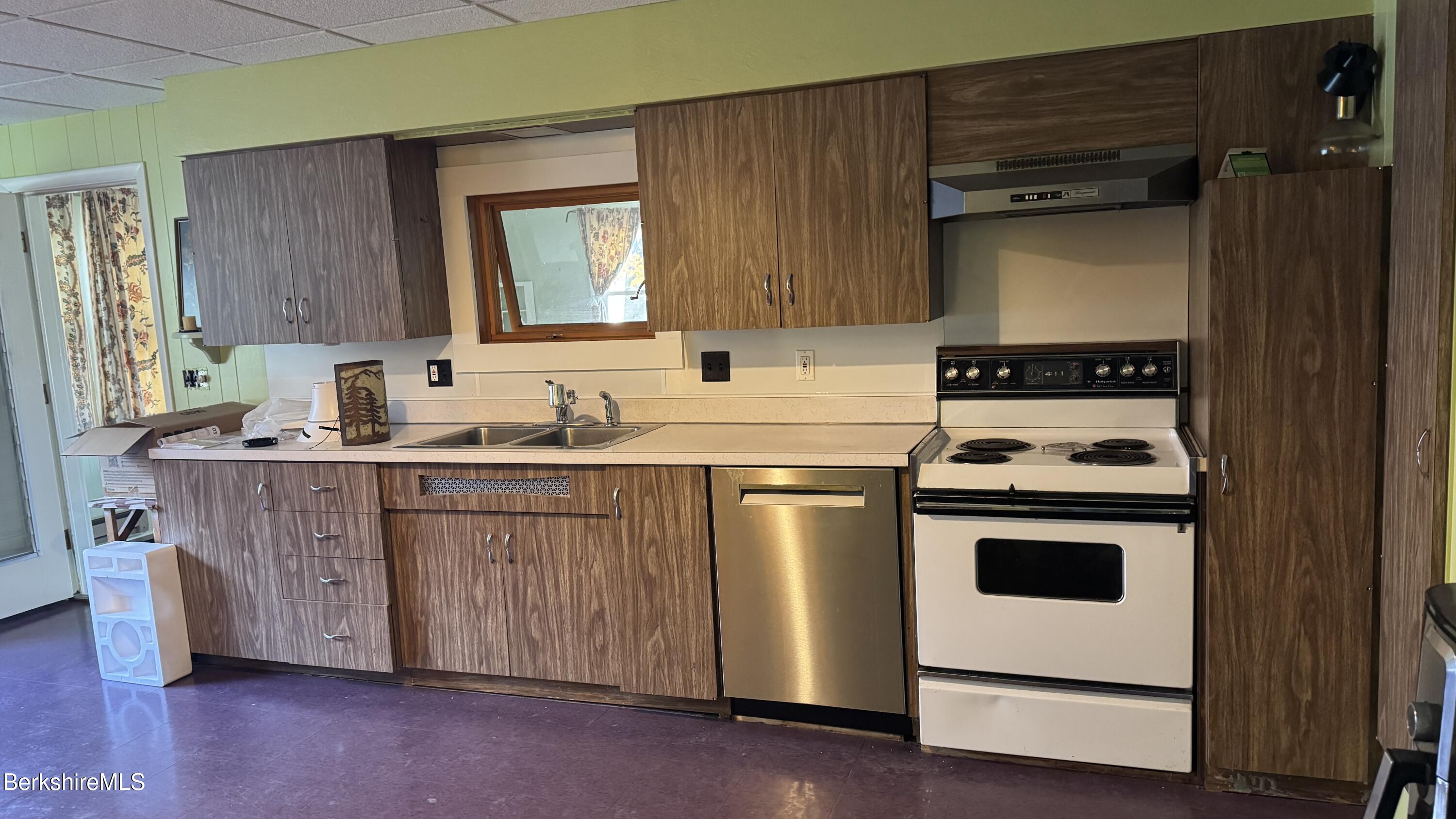 152 Furnace Street North Adams, MA 01247 - Photo 6 of 30 a kitchen with sink a stove and white cabinets