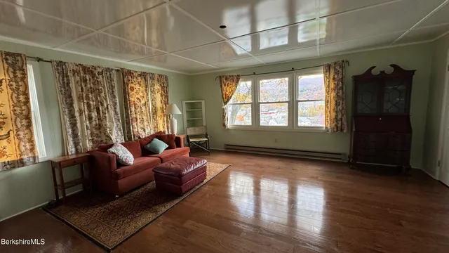 a living room with furniture and large windows