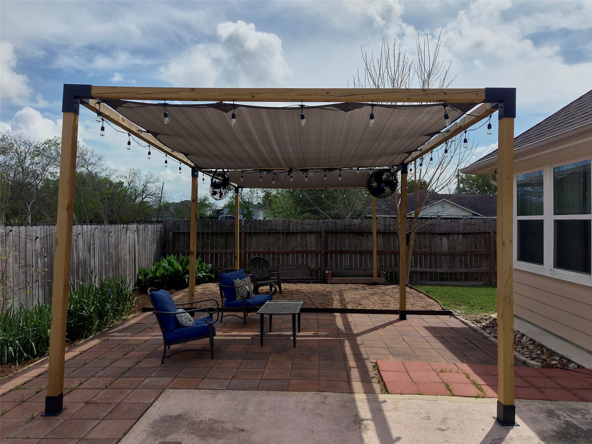 4219 Redbud Street Houston, TX 77051 - Photo 22 of 25 Unwind in your own serene backyard oasis, featuring a stylish pergola and inviting seating area perfect for relaxation.